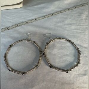 Large silvertone hoop earrings with black accents